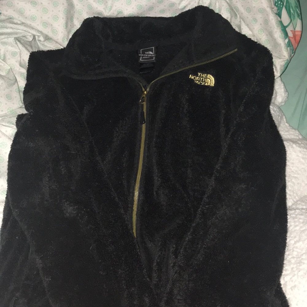 Black and gold north face jacket